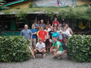 A group of happy customers gathers in front of the gallery.